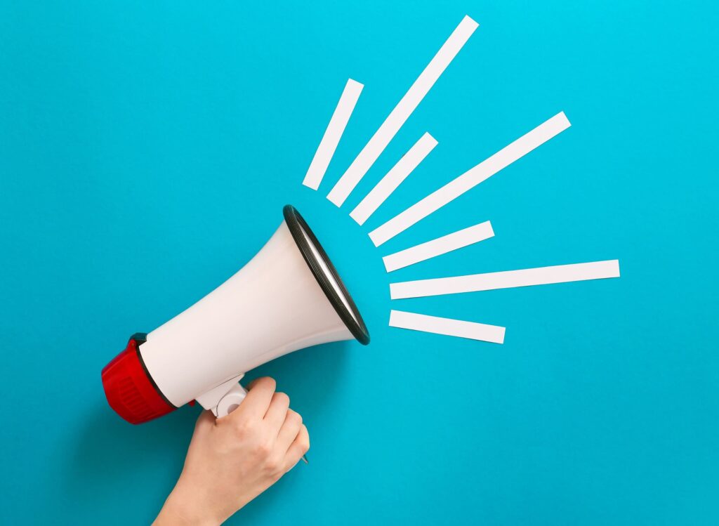 Hand holding a megaphone