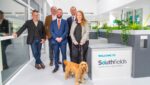 Presenter Nick Baker pictured at Southfields veterinary hospital with staff and spaniel