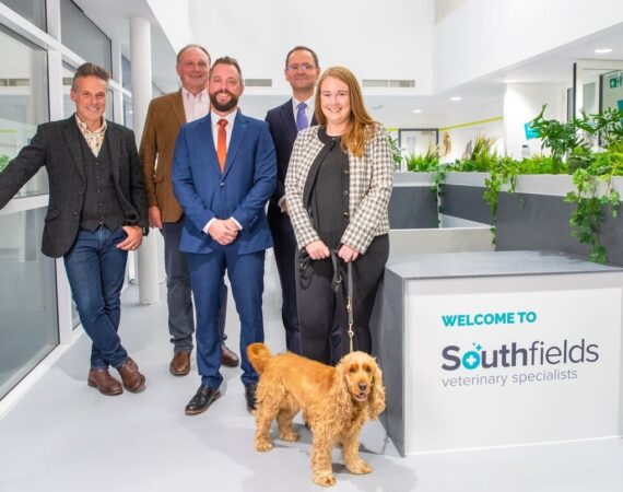 Presenter Nick Baker pictured at Southfields veterinary hospital with staff and spaniel