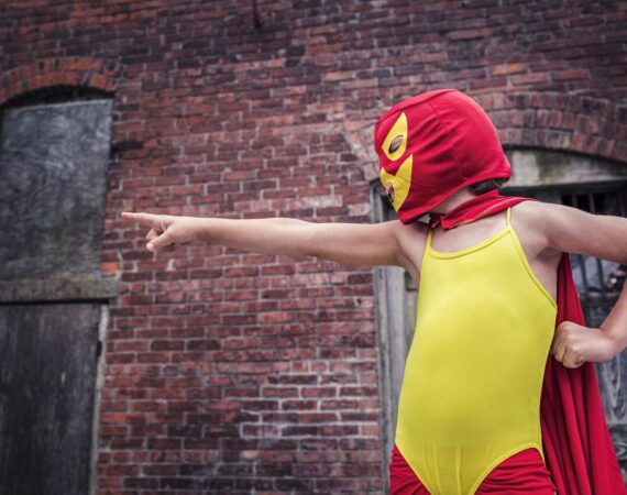 Standing out - a child dressed in yellow and red superhero outfit