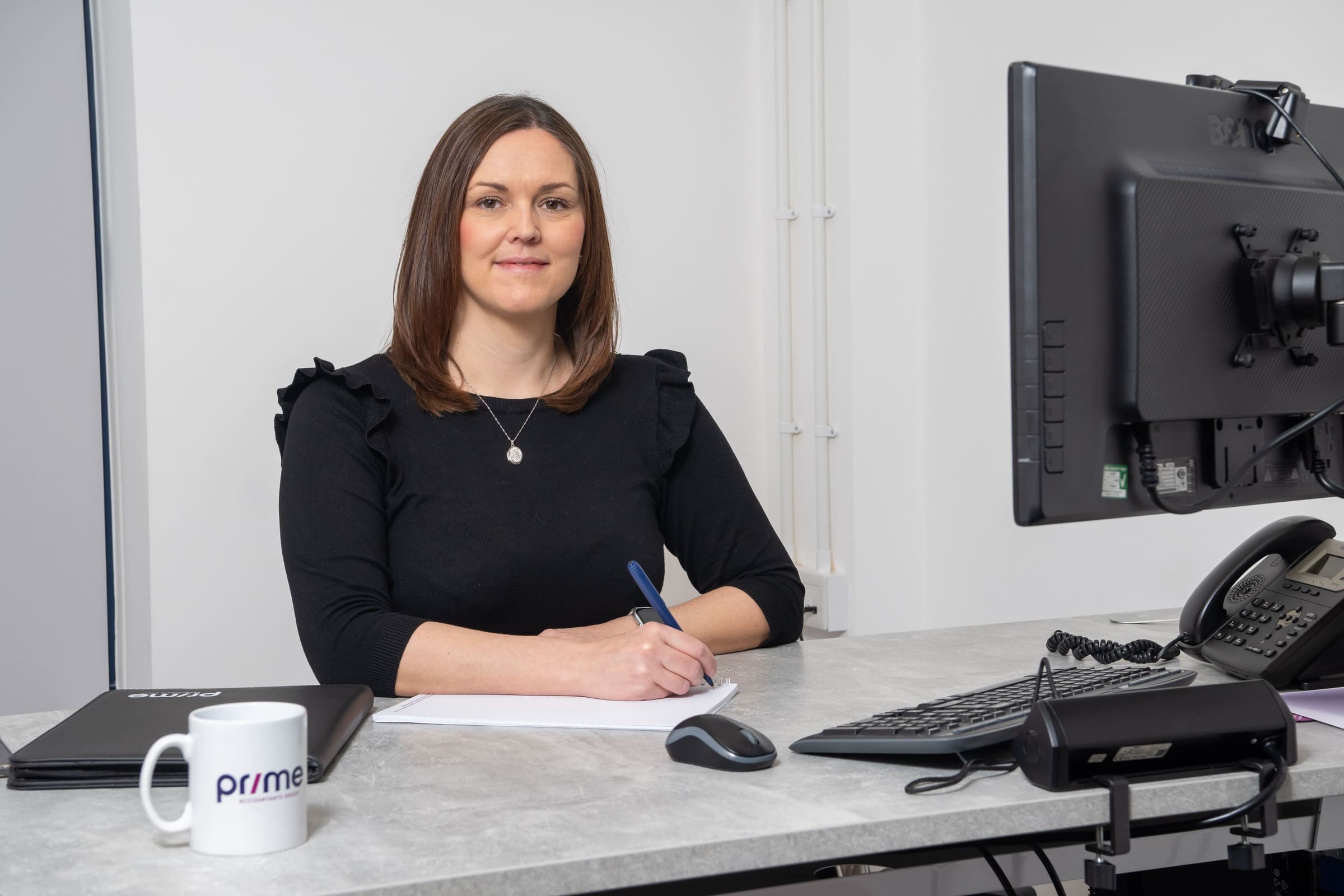 Paislei Godley of Prime Accountants sat at a desk