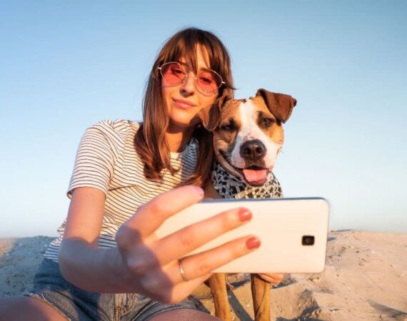 Influencer taking a selfie with her dog