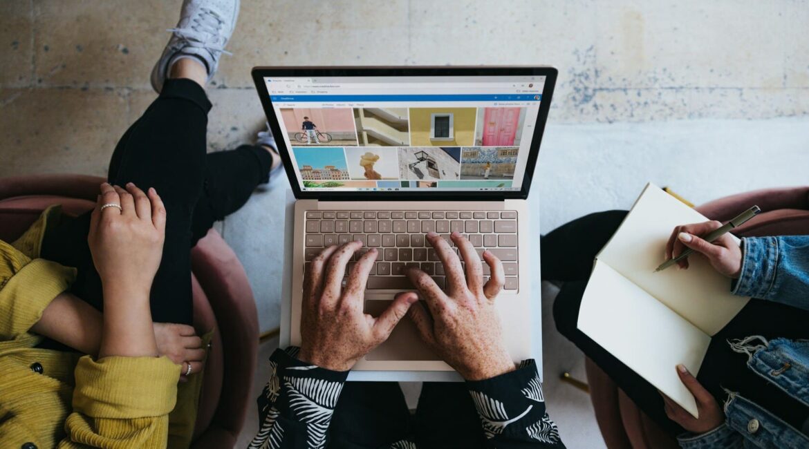 Someone looking at social media on a laptop balanced on their knee