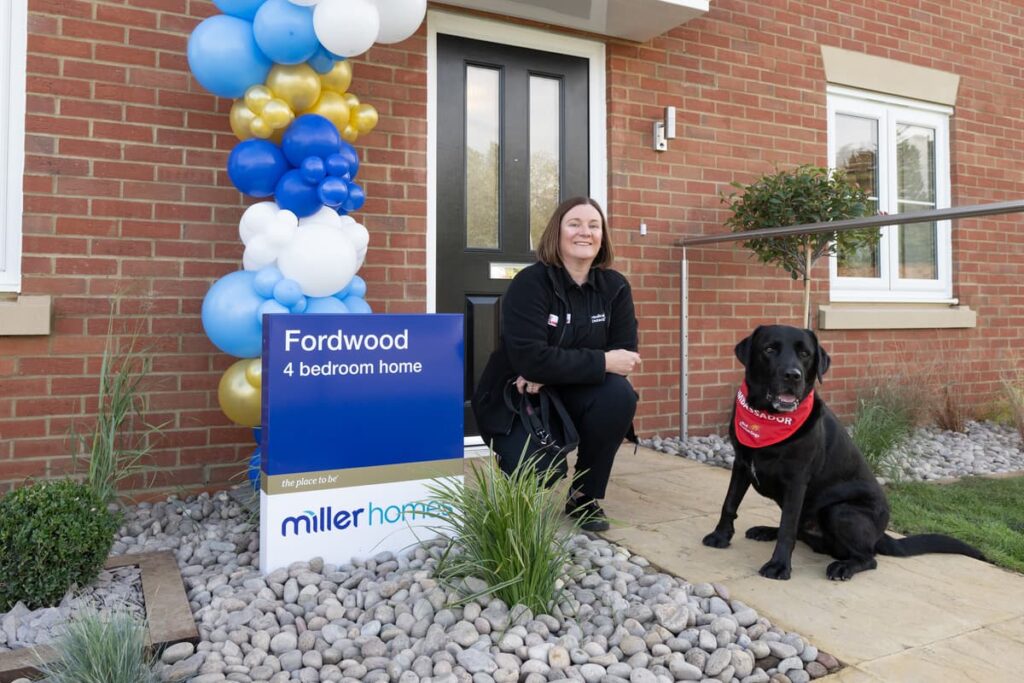 Woman sits outside home with medical detection dog