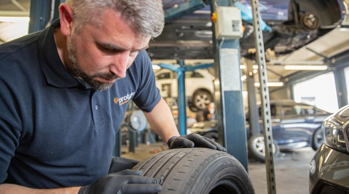 Mechanic looks at wheel