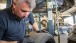 Mechanic looks at wheel