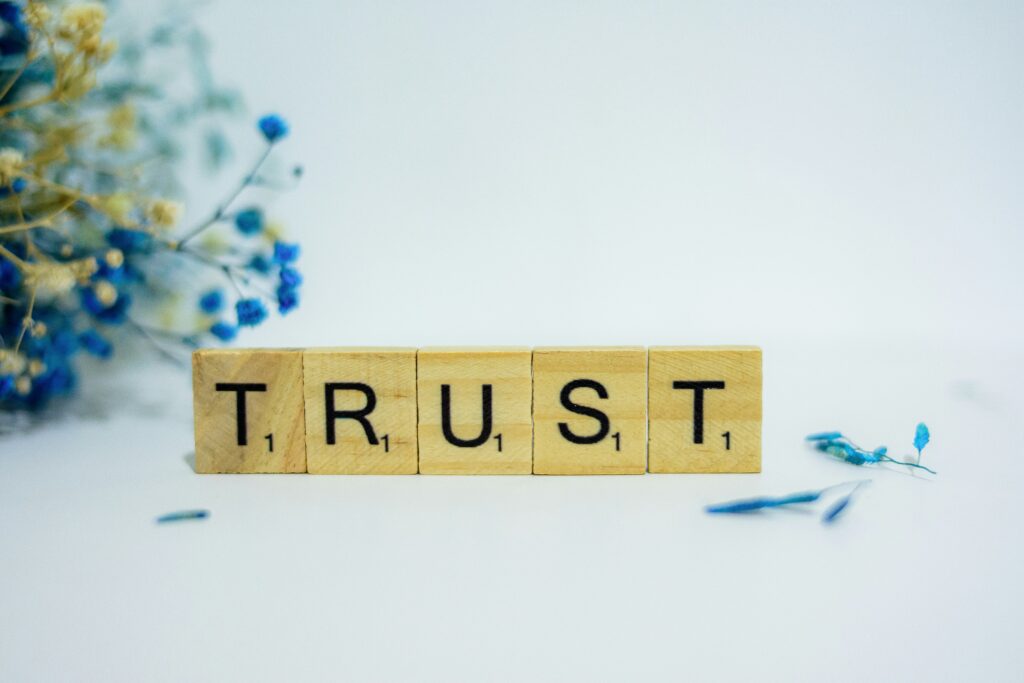 The word Trust spelt out in Scrabble letters