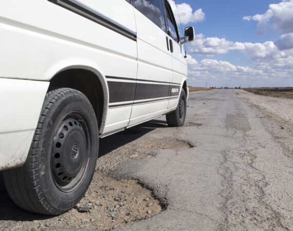 A car driving over a pothole