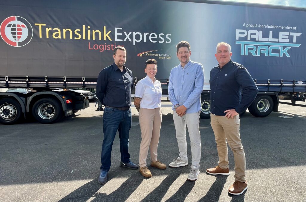 People stood in front of a Translink Express Logistics vehicle
