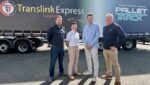 People stood in front of a Translink Express Logistics vehicle