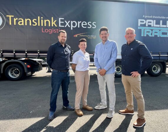 People stood in front of a Translink Express Logistics vehicle