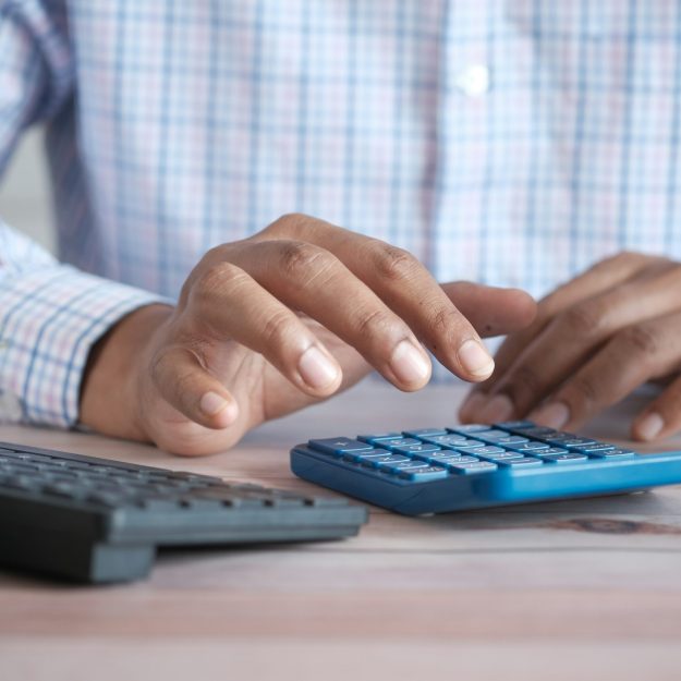 A man in a shirt using a calculator
