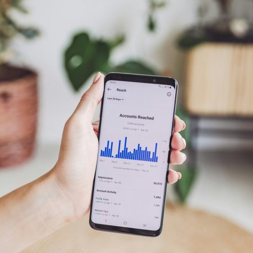 Mobile phone showing paid social media analytics